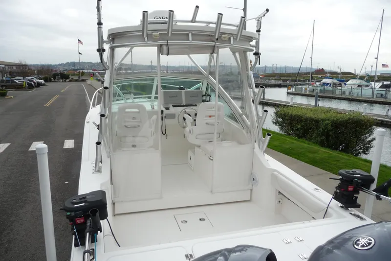 Slide: The Image of 2016 Albemarle 25 Express boat docked at marina, featuring dual seats and fishing equipment. - 11