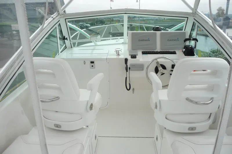 Slide: The Image of 2016 Albemarle 25 Express boat cockpit with dual Garmin displays and white seating. - 13