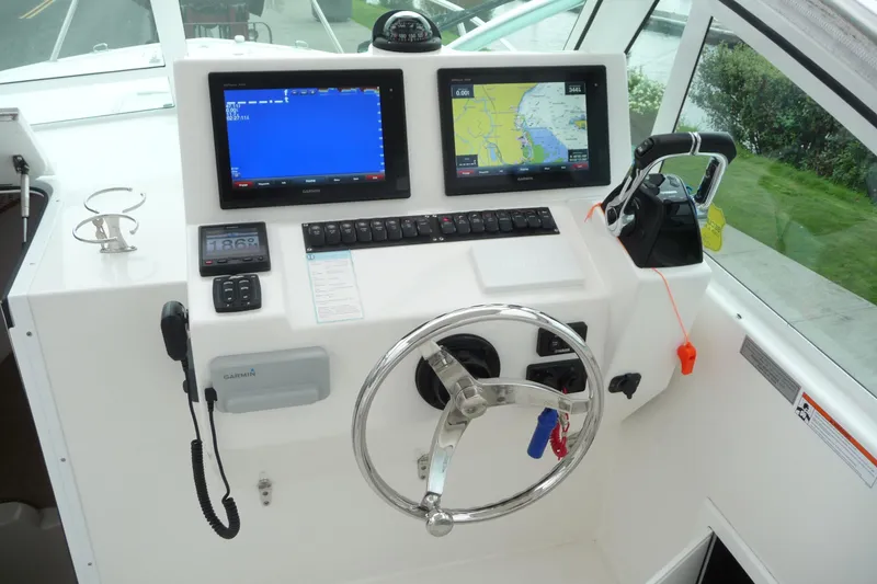 Slide: The Image of 2016 Albemarle 25 Express helm with dual Garmin displays and steering wheel. - 14