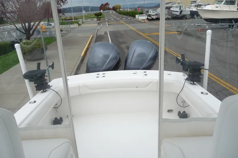 Slide: The Image of 2016 Albemarle 25 Express boat with dual engines at a marina. - 15