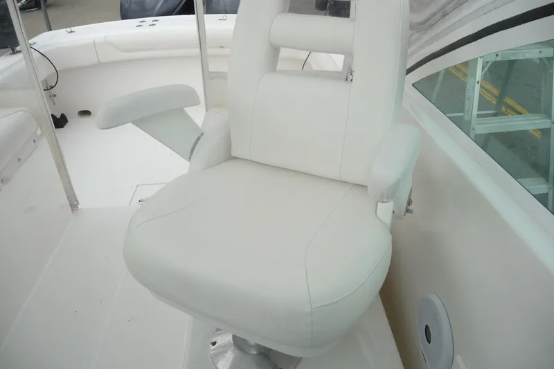 Slide: The Image of White captain's chair on 2016 Albemarle 25 Express boat interior. - 17