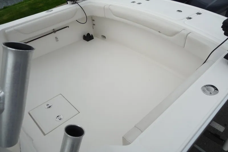 Slide: The Image of 2016 Albemarle 25 Express boat interior, featuring spacious white deck and storage compartments. - 18