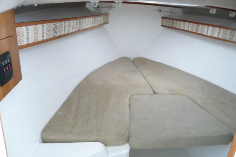 Slide: The Image of 2016 Albemarle 25 Express cabin interior with beige cushions and wood accents. - 19