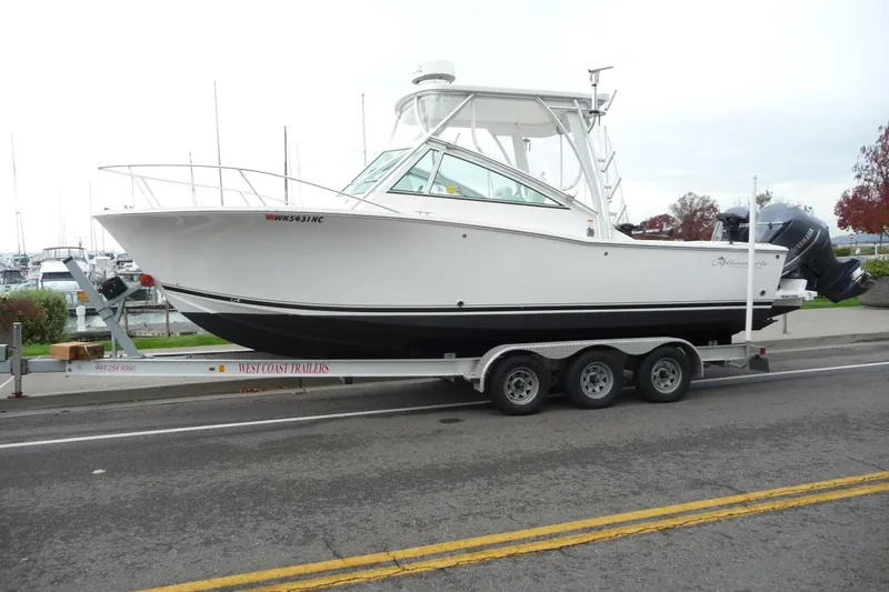 Slide: The Image of 2016 Albemarle 25 Express boat on trailer, parked near marina. - 2