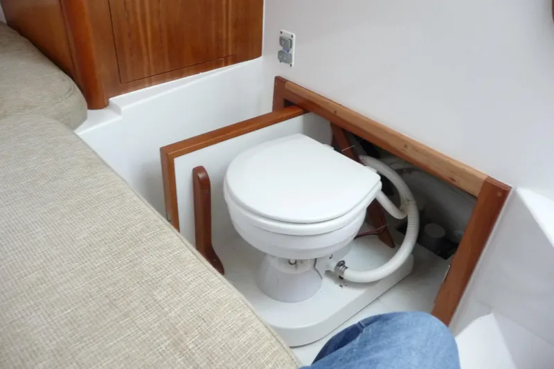 Slide: The Image of 2016 Albemarle 25 Express boat interior with compact marine toilet. - 21
