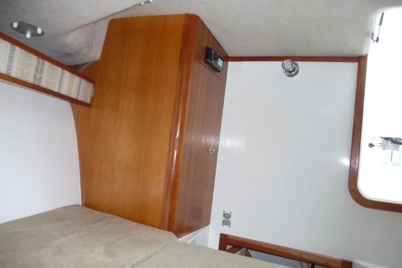 Slide: The Image of Interior cabin of 2016 Albemarle 25 Express boat with wood paneling and seating. - 22