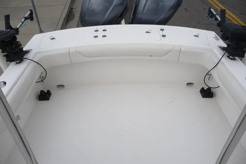 Slide: The Image of 2016 Albemarle 25 Express boat deck with fishing rod holders and storage compartments. - 23