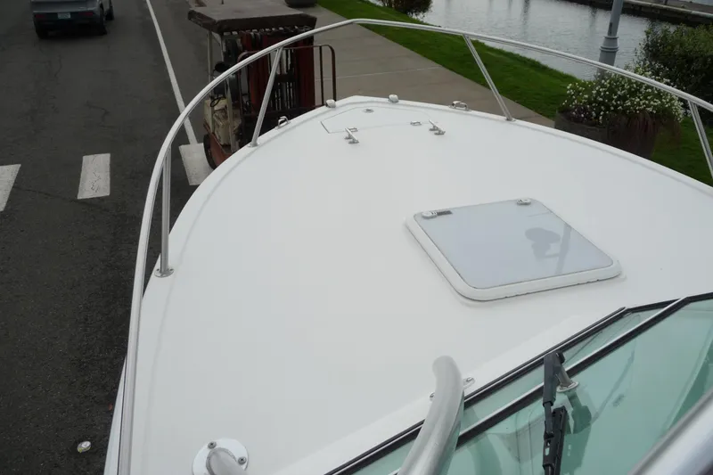 Slide: The Image of 2016 Albemarle 25 Express boat deck with hatch, docked near a waterfront. - 25