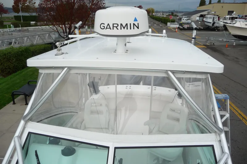 Slide: The Image of 2016 Albemarle 25 Express boat with Garmin radar, docked near marina. - 26