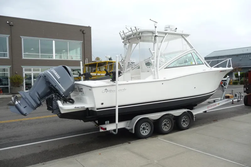 Slide: The Image of 2016 Albemarle 25 Express boat on trailer with Yamaha outboard motor, parked near buildings. - 9