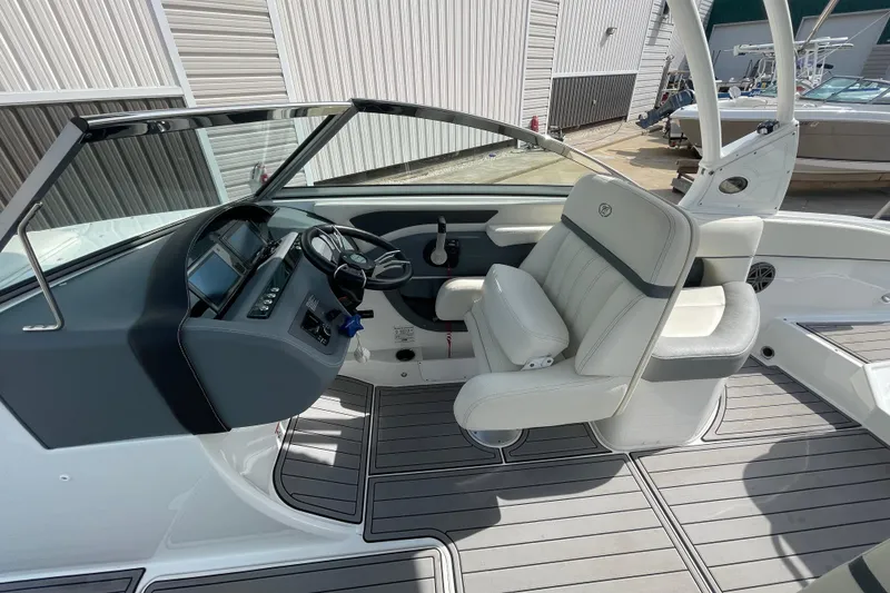 Slide: The Image of 2018 Cobalt 25SC boat interior with steering wheel and seating, featuring modern design. - 18