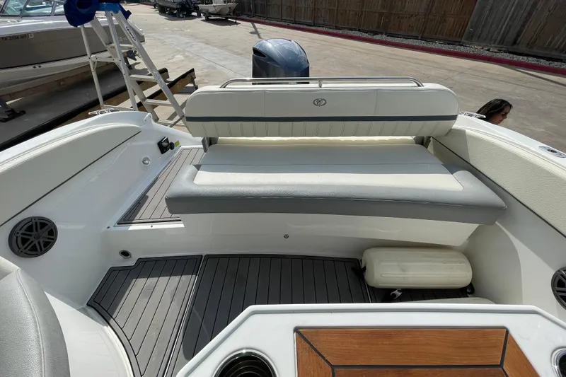 Slide: The Image of 2018 Cobalt 25SC boat interior with cushioned seating and teak accents. - 20