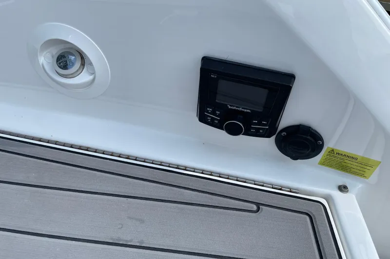 Slide: The Image of 2018 Cobalt 25SC boat dashboard with Rockford Fosgate stereo system and warning label. - 22
