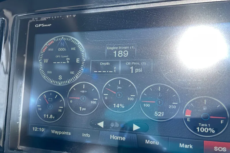 Slide: The Image of Dashboard of a 2018 Cobalt 25SC boat showing engine hours and gauges. - 25
