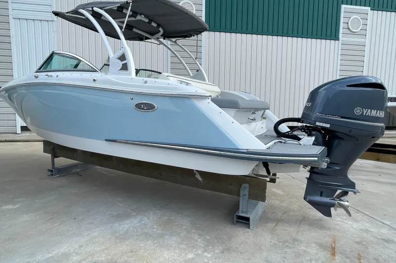 Slide: The Image of 2018 Cobalt 25SC boat with Yamaha outboard motor, docked on a concrete surface. - 4