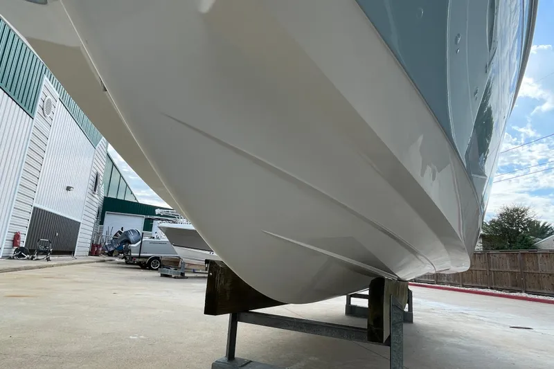 Slide: The Image of 2018 Cobalt 25SC boat hull on display at a marina. - 6
