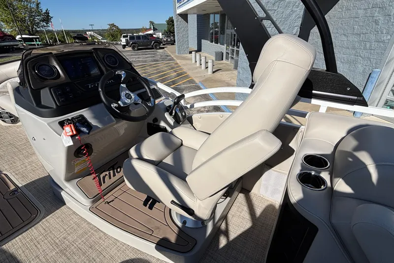 Slide: The Image of 2026 JC Neptoon 25TT Sport boat interior with steering console and seating. - 13