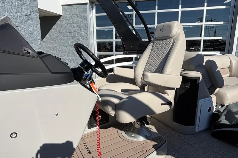 Slide: The Image of 2026 JC Neptoon 25TT Sport boat interior with captain's chair and steering wheel. - 15