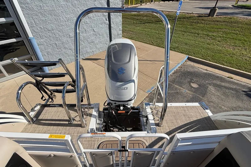 Slide: The Image of 2026 JC Neptoon 25TT Sport boat with Suzuki outboard motor, docked on pavement. - 4