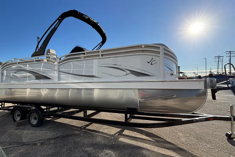 Slide: The Image of 2026 JC Neptoon 25TT Sport pontoon boat on trailer under bright sun. - 7