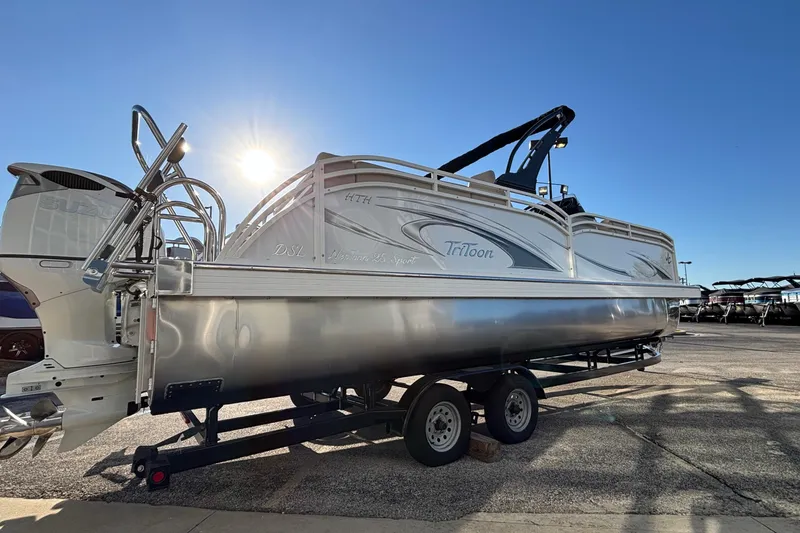Slide: The Image of 2026 JC Neptoon 25TT Sport pontoon boat on trailer, sunlit background. - 8