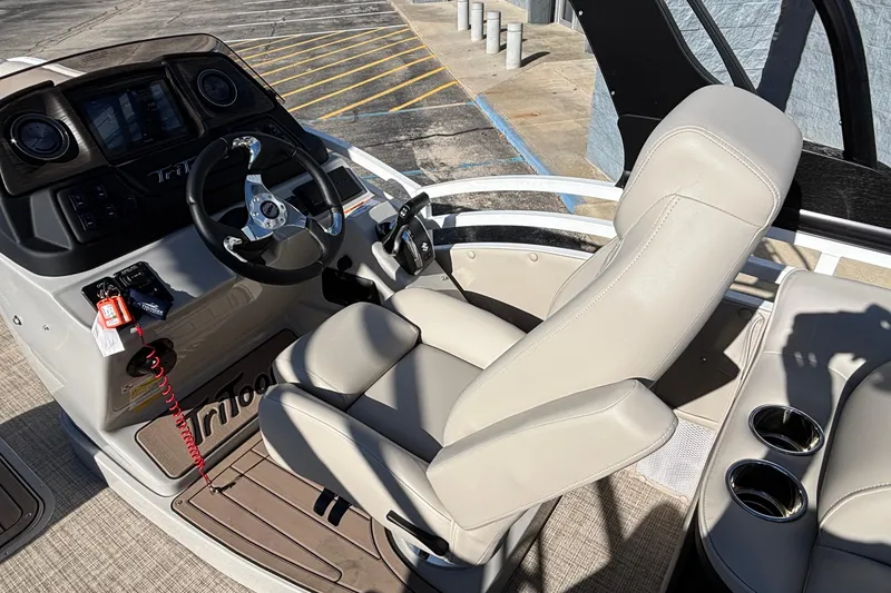 Slide: The Image of 2026 JC Neptoon 25TT Sport boat helm with steering wheel and captain's chair. - 14