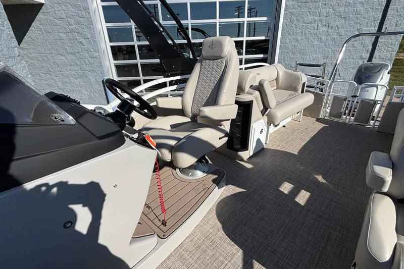 Slide: The Image of 2026 JC Neptoon 25TT Sport boat interior with steering console and seating. - 22