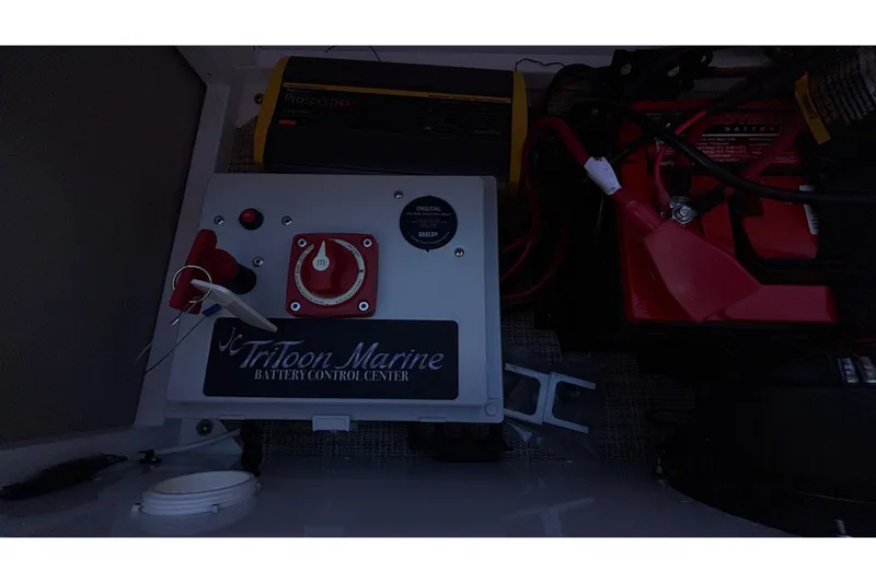 Slide: The Image of Battery control center of JC Neptoon 25TT Sport 2026 with wiring and switches. - 24