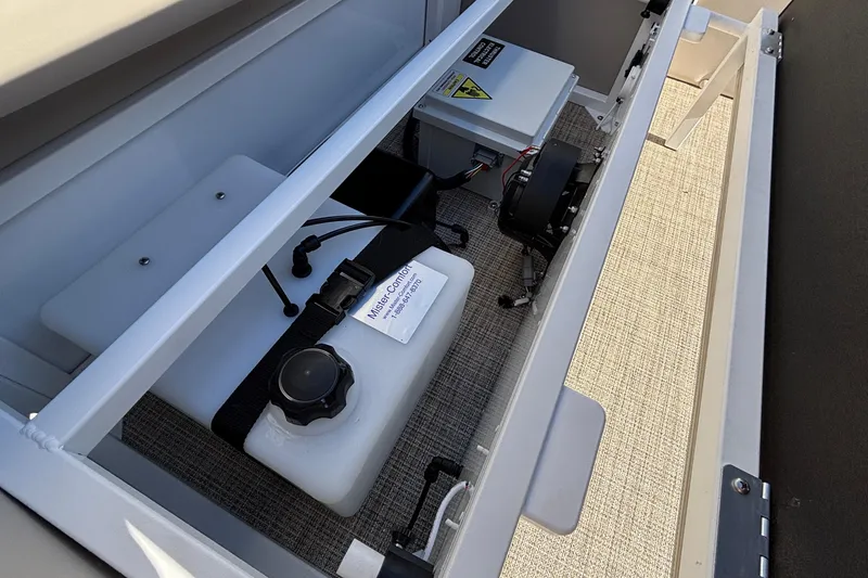 Slide: The Image of Storage compartment of 2026 JC Neptoon 25TT Sport boat with equipment and wiring. - 25