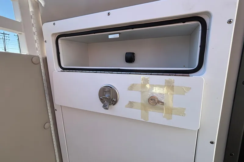 Slide: The Image of Storage compartment with taped lock on 2026 JC Neptoon 25TT Sport boat. - 29
