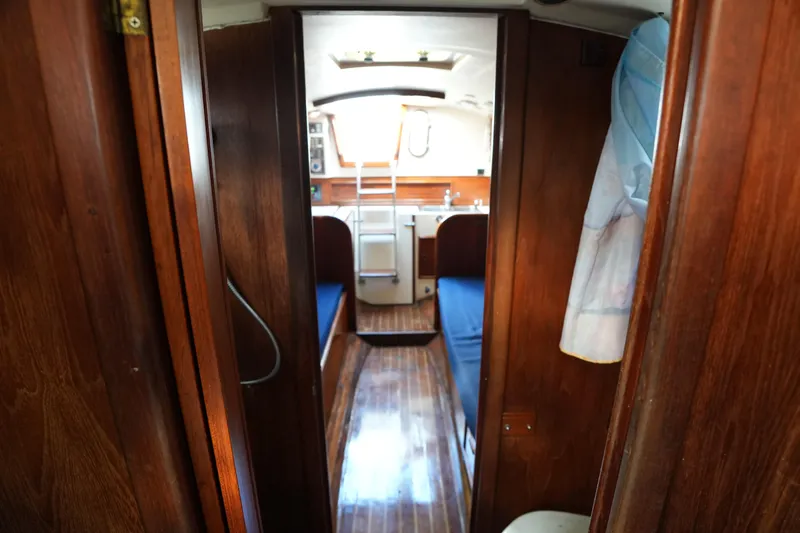 Slide: The Image of Interior of 1983 Cape Dory 30c sailboat with wooden finish and blue seating. - 19