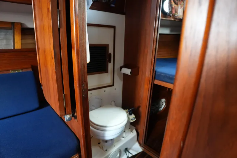 Slide: The Image of Interior of 1983 Cape Dory 30c sailboat featuring a compact wooden bathroom. - 20