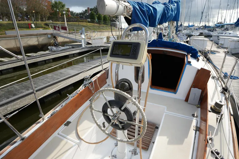 Slide: The Image of 1983 Cape Dory 30c sailboat cockpit with steering wheel and navigation equipment. - 22