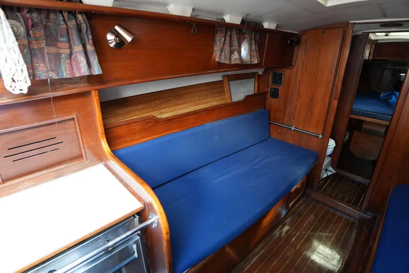 Slide: The Image of Interior of 1983 Cape Dory 30c sailboat with blue seating and wooden finishes. - 27