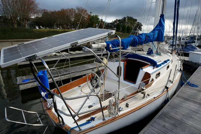 Slide: The Image of 1983 Cape Dory 30c sailboat with solar panels docked at marina. - 8