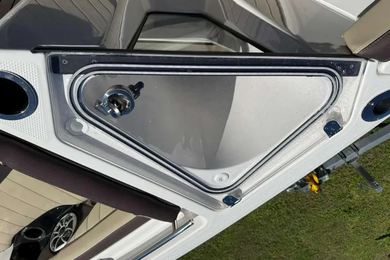 Slide: The Image of 2023 Yamaha Boats 255 FSH Sport E, open storage compartment detail. - 16