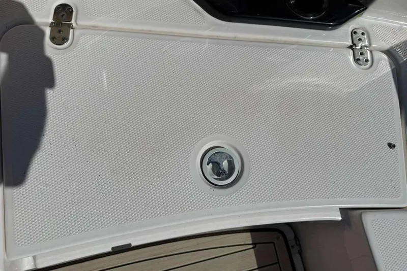 Slide: The Image of 2023 Yamaha Boats 255 FSH Sport E deck with textured surface and latch. - 18