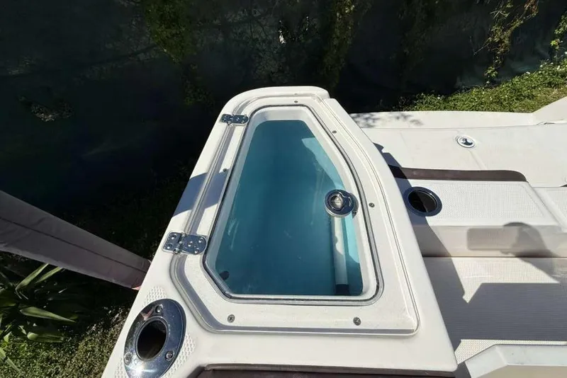 Slide: The Image of 2023 Yamaha Boats 255 FSH Sport E livewell, featuring a clear lid and stainless steel fittings. - 25