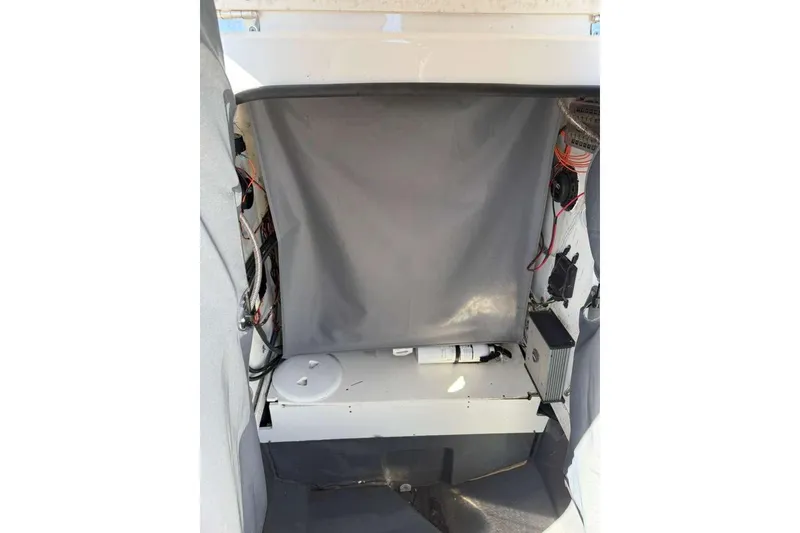 Slide: The Image of 2023 Yamaha Boats 255 FSH Sport E interior wiring and storage compartment. - 29