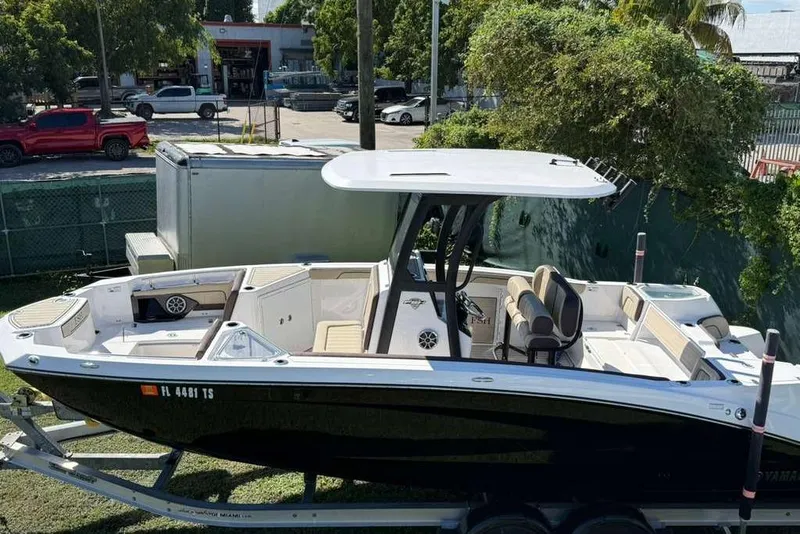 Slide: The Image of 2023 Yamaha Boats 255 FSH Sport E on trailer, parked outdoors. - 3