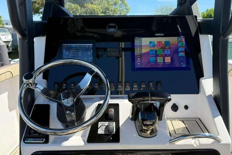 Slide: The Image of 2023 Yamaha Boats 255 FSH Sport E dashboard with steering wheel and digital displays. - 4