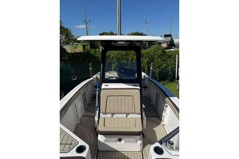 Slide: The Image of 2023 Yamaha Boats 255 FSH Sport E, interior view with seating and console. - 5