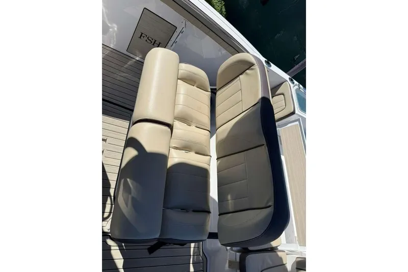 Slide: The Image of 2023 Yamaha Boats 255 FSH Sport E seating, featuring beige cushioned seats on deck. - 9