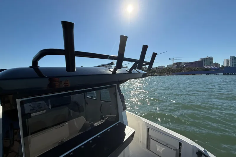 Slide: The Image of Navan C30 boat on water, sunny day, city skyline in background, 2026 model. - 18