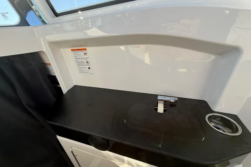 Slide: The Image of Interior of 2026 Navan C30 boat featuring a sleek black countertop and modern faucet. - 29