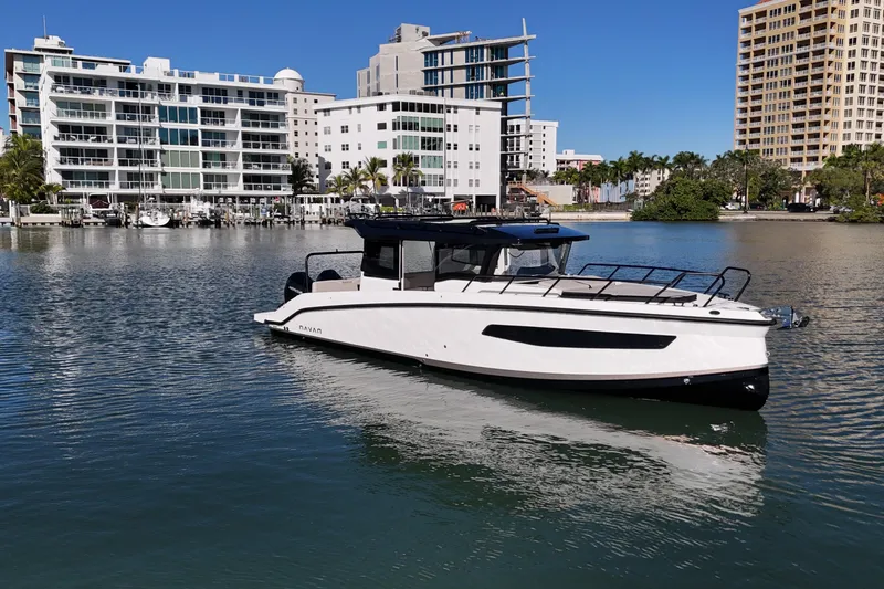 Slide: The Image of 2026 Navan C30 boat on calm water with modern buildings in the background. - 3