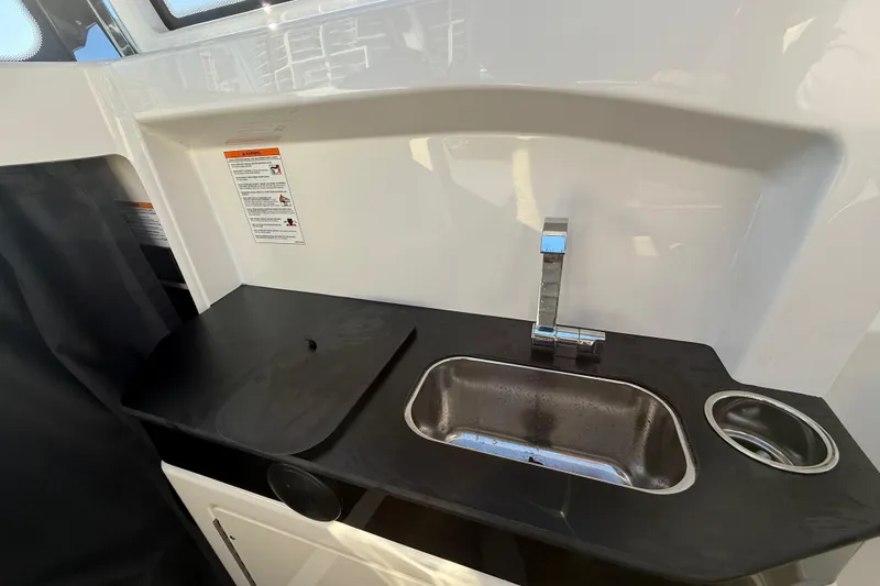 Slide: The Image of Compact kitchen sink area in 2026 Navan C30 with modern faucet and countertop. - 30