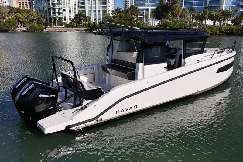 Slide: The Image of 2026 Navan C30 boat with dual Mercury engines on a calm waterway. - 5