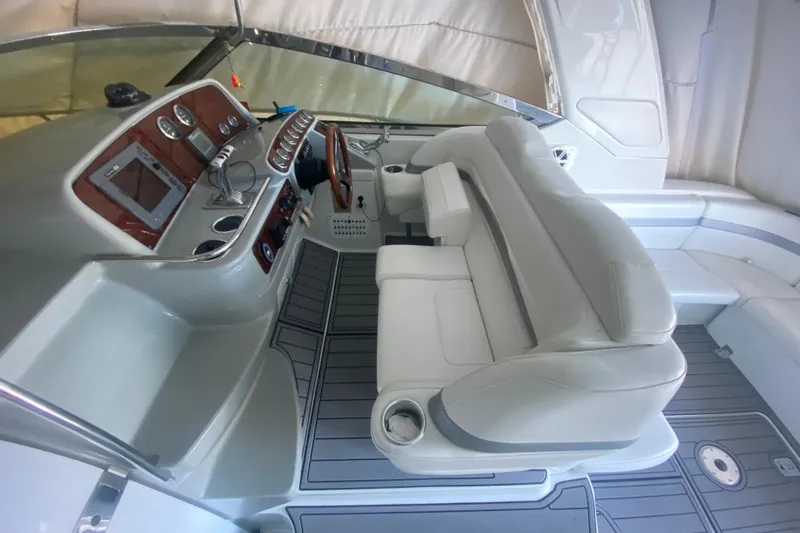 Slide: The Image of 2005 Formula 40 Performance Cruiser interior with seating and storage, overlooking a serene lake. - 13