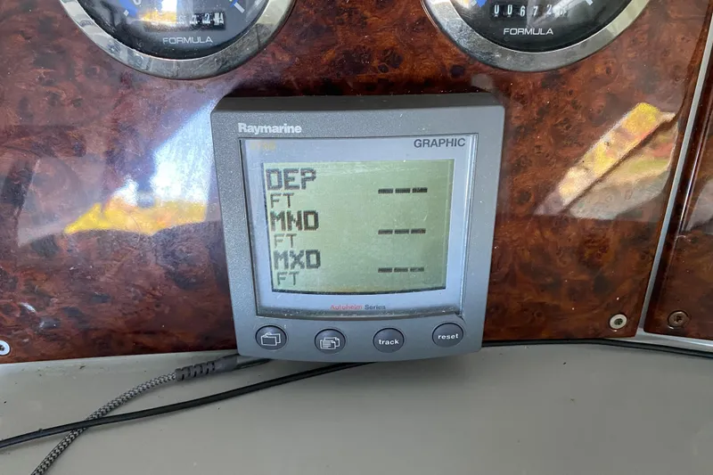 Slide: The Image of 2005 Formula 40 Performance Cruiser cockpit with white seating and modern dashboard. - 17